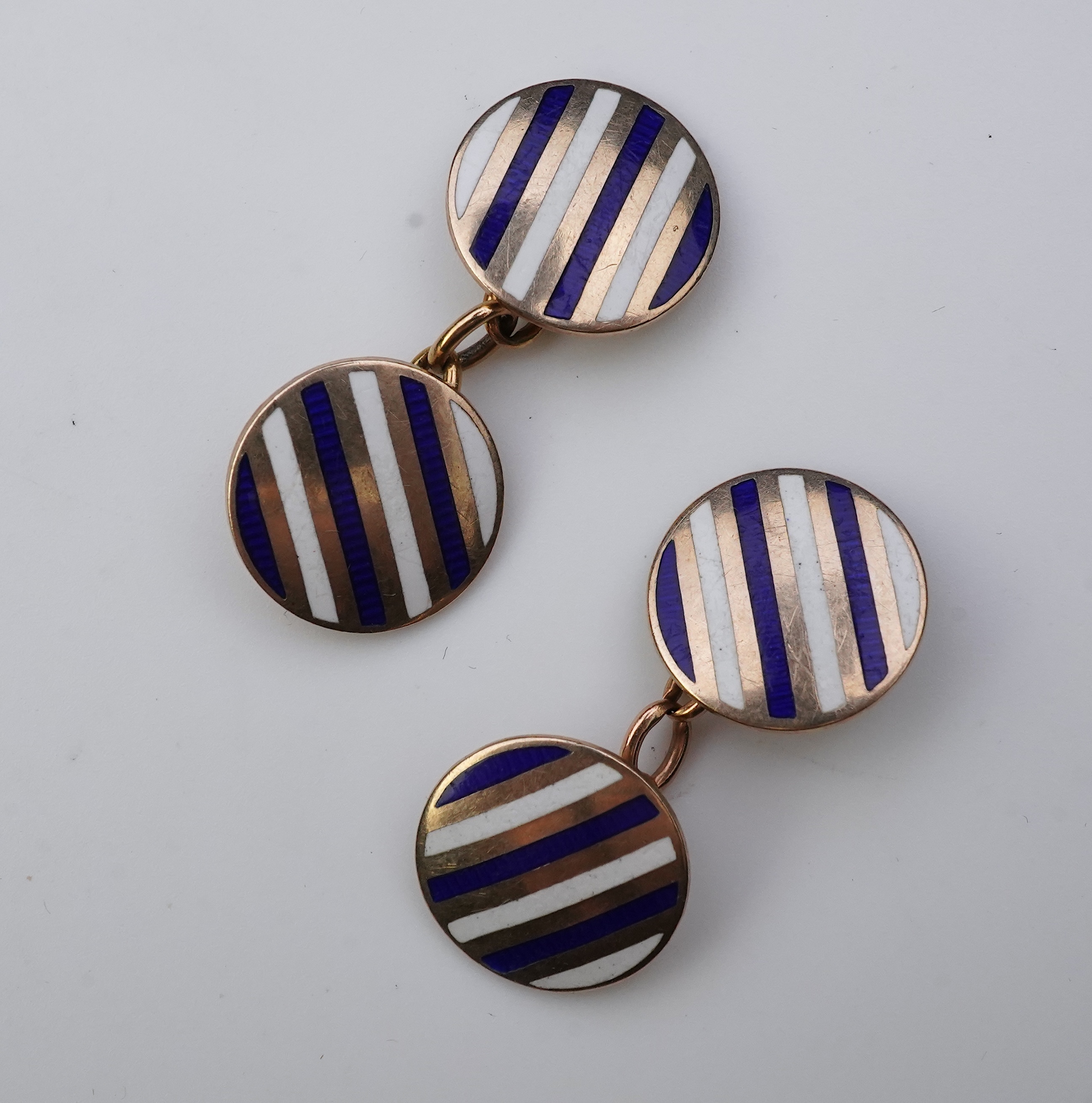 A pair of gold and enamel cufflinks